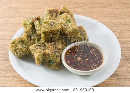 Plate Of Fried Chinese Pancake Or Fried Steamed Dumpling Made Of Garlic Chives, Rice Flour And Tapio
