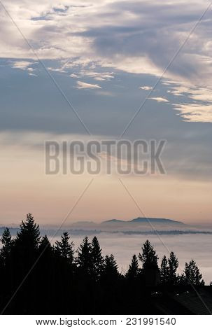 Sunset Over Vancouver Above The Clouds Across The Ocean From The North Shore