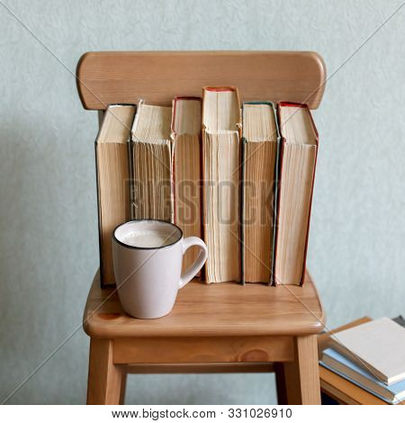 Hot Coffee Or Tea, Cocoa, Chocolate Cup And Old Books On Wooden Chair. Concept Of Stydy Education, T