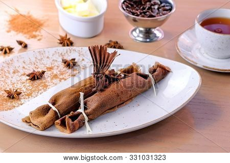 Chocolate Russian Pancakes, Blini With Curd Filling On The Plate