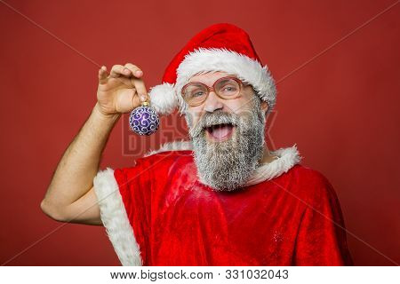 Santa Claus Hands New Years Toy. Bearded Santa Claus With Long Beard In New Year Hat, Santa Beard. H