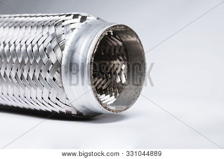 Full-contrast Image Flexible Connection To The Exhaust System Of A Passenger Car On A Gray Gradient 