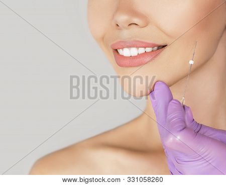 Face Contour Lifting Procedure. Needle With Mesothreads Near The Female Face, Macro