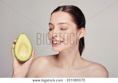 Attractive Happy And Cheerful Lady With Pure Shine Skin With Avocado