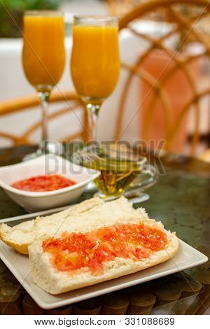 Traditional Andalusian Breakfast With Freshly Squeezed Orange Juice, Bread Toasts, Fresh Ground Toma
