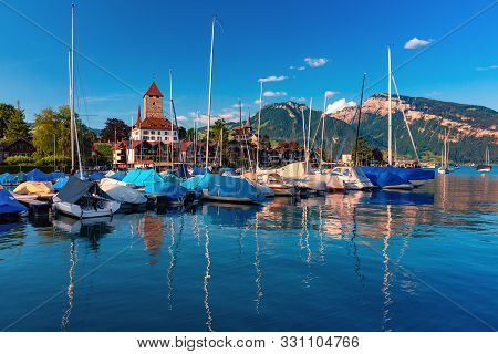Spiez Church And Castle On The Shore Of Lake Thun With Yachts In The Swiss Canton Of Bern At Sunset,