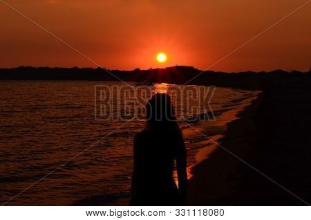 Silhouette Mof Women  On Beach Against Sky During Sunset