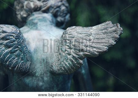 Angel Wings. Fragment Of Bronze Sculpture At Old Cemetery.