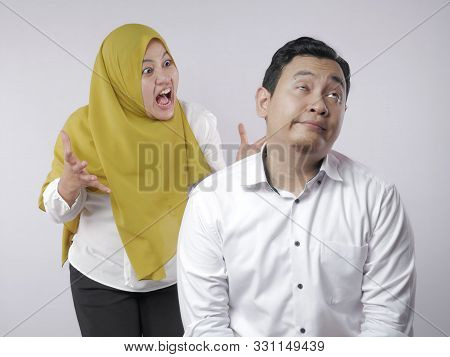 Portrait Of Muslim Couple Having Conflict, Husband Ignoring His Wife Screaming, Couple Argue
