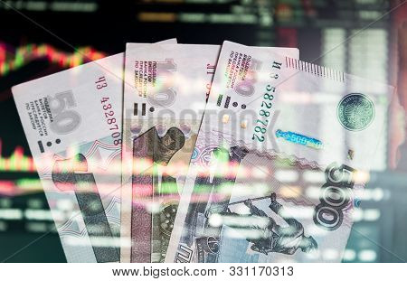 The Russian Ruble On The Background Of The Trading Chart. A Thousand Rubles Close-up. Fall Or Rise O