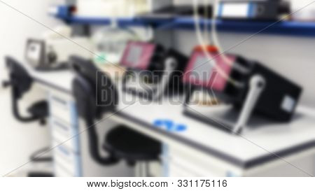 The Background Is Blurry. Devices Are On The Tables In The Test Laboratory.