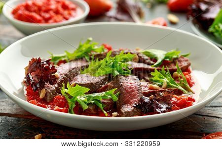 Beef Steak With Romesco Sauce, Nuts And Vegetables On White Plate
