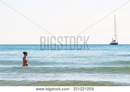 Tenda Gialla, Province Of Grosseto, Tuscany, Italy - September 03, 2019: Young Woman Standing In The