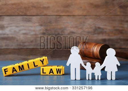 Figure In Shape Of People, Cubes With Words Family Law And Gavel On Blue Wooden Table