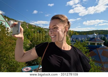 Mont-tremblant Resort, Woman Tourists Makes Selfie With Phone On A Funicular In Quebec Canada