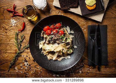 Black Angus pappardelle pasta with beef, champignon and parmegano cheese