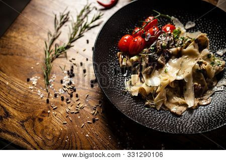 Black Angus pappardelle pasta with beef, champignon and parmegano cheese