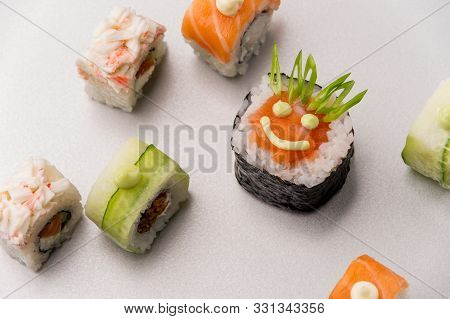 Lovely Shot Of Rolls On A White Table With One Of Them Having Smiling Face Pictured With A Mayonnais
