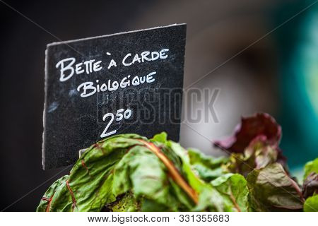 Sign Saying Organic Swiss Chard In French Or Bette A Carde Biologique. Closeup Picture On The Sign M