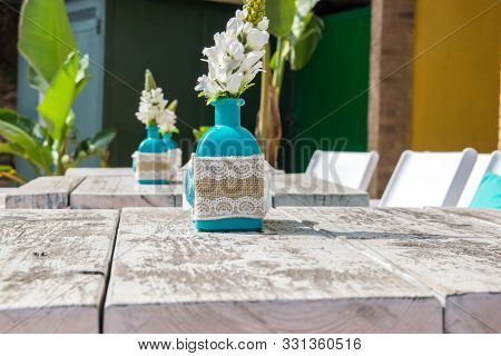 Warehouse On The Open Air. Chairs And Tables Outside On The Summer Sun Weather. Vase With The Flower
