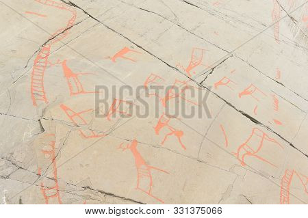 Rock Art In Alta Fjord, Norway. Ancient Symbols, Real Drawing,  Texture In Stone. Red Ocher Paint. H