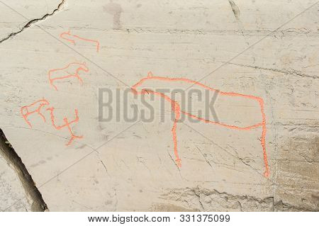 Rock Art In Alta Fjord, Norway. Ancient Symbols, Real Drawing,  Texture In Stone. Red Ocher Paint. H