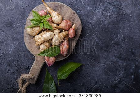 Jerusalem Artichokes Or Topinambour, (topinambur), Also Known As Earth Apple Or Sunroot On A Cutting