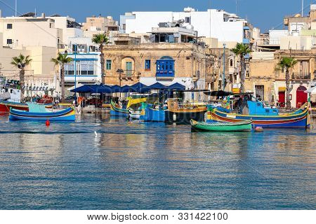 Multicolored Fishing Boats Luzzu With Eyes In The Harbor. Marsaxlokk. Malta.