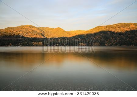 Serene Lake At Sunset With Clear Smooth Water On Lake