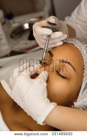 Afro American Young Patient Having Modern Noninvasive Procedure Of Rhinoplasty. Beautician Injects S