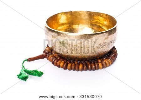 Closeup Of A Singing Bowl And A Japamala On A White Background
