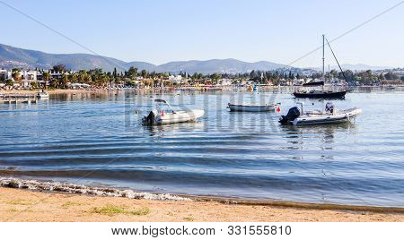 Beautiful Bay With Calm Water, Sandy Beach, Boats And Yachts. Small Town And Green Mountains On The 