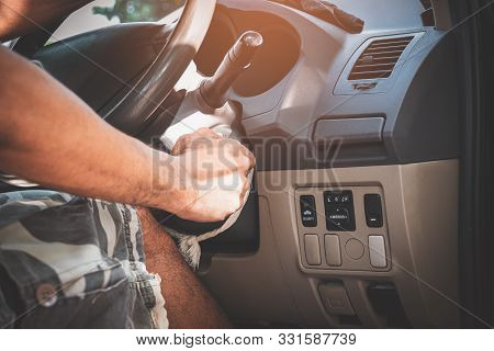 Close Up Of A Man's Hand With The Key To Start The Car's Engine.
