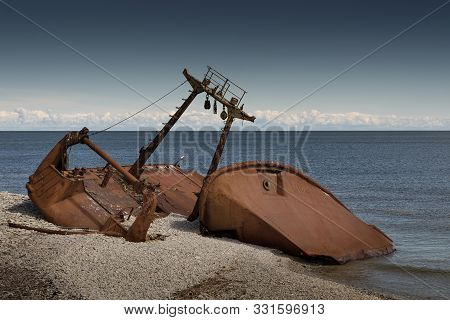 Old Rusty Wreck And Rocky Beach In Baltic Sea, Natural Environment. Osmussaar, Estonia, Europe.