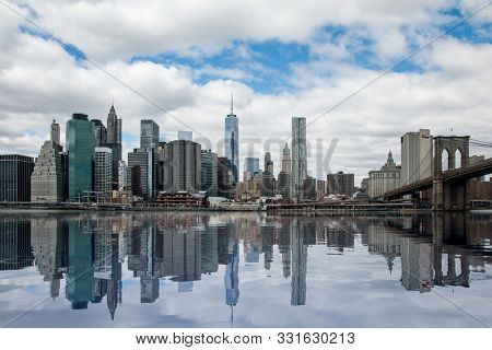 NEW YORK, NY, USA -  APRIL 283, 2014: Panorama of Manhattan in New York City with artificial water showing reflections from skyline