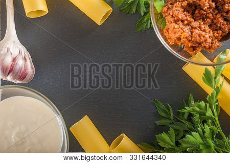 Cannelloni On A Plate With Meat And Tomato Sauce. Italian Paste. Crude Cannelloni On A Kitchen Table
