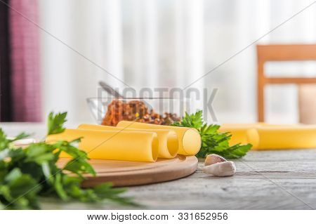 Cannelloni On A Plate With Meat And Tomato Sauce. Italian Paste. Crude Cannelloni On A Kitchen Table