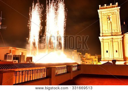 Colorful Fireworks In Pyromusical Show Next To The Bell Tower Of Santa María Church In Elche