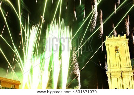 Colorful Fireworks In Pyromusical Show Next To The Bell Tower Of Santa María Church In Elche