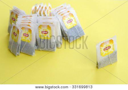Lipton Yellow Label Black Tea Bags On Pastel Yellow Surface Close Up. Lipton Is A World Famous Brand