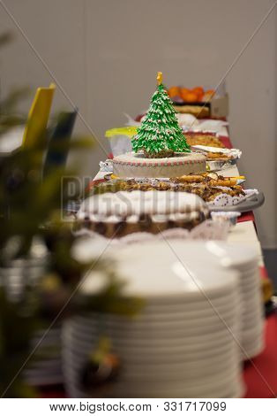 Simple Fruit Cake Dekorated With An Eatable Christmas Tree Pops Out Amonst Other Pies And Cakes On A