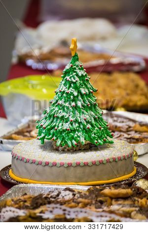 Simple Fruit Cake With Marzipan Dekorated With An Eatable Christmas Tree Pops Out Amonst Other Pies 