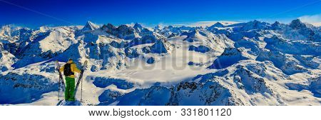 Skitouring with amazing view of swiss famous mountains in beautiful winter powder snow of Alps. 