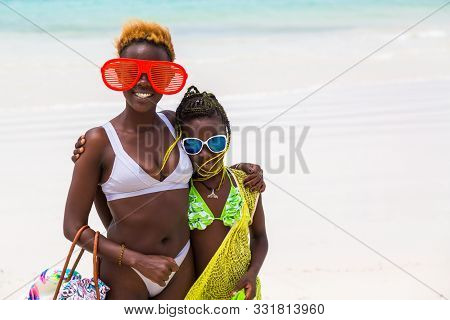 Diani Beach, Ukunda, Kenya - August, 2019: African Family With Young African Smiling Woman With Funn