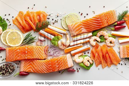 Fresh Seafood On A Table With Spices, Vegetables And Olive Oil: Fresh And Smoked Salmon, Shrimp And