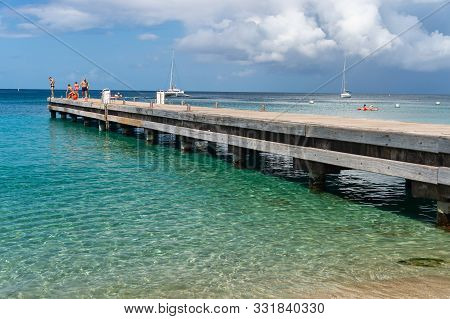 Petite Anse, Martinique, France - 18 August 2019: Wood Pontoon And Turquoise Water