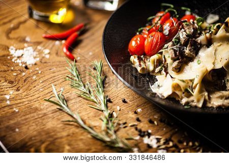 Black Angus pappardelle pasta with beef, champignon and parmegano cheese