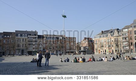 Leuven, Belgium - April 1, 2019: People At The Big Square Where Is Located A Giant Shiny Green Beetl