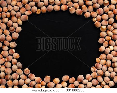 Natural Organic Hazelnut On A Black Background. Top View. Healthy Eating Concept. Natural Light. Foo
