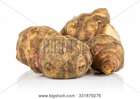 Group Of Four Whole Fresh Brown Jerusalem Artichoke Isolated On White Background